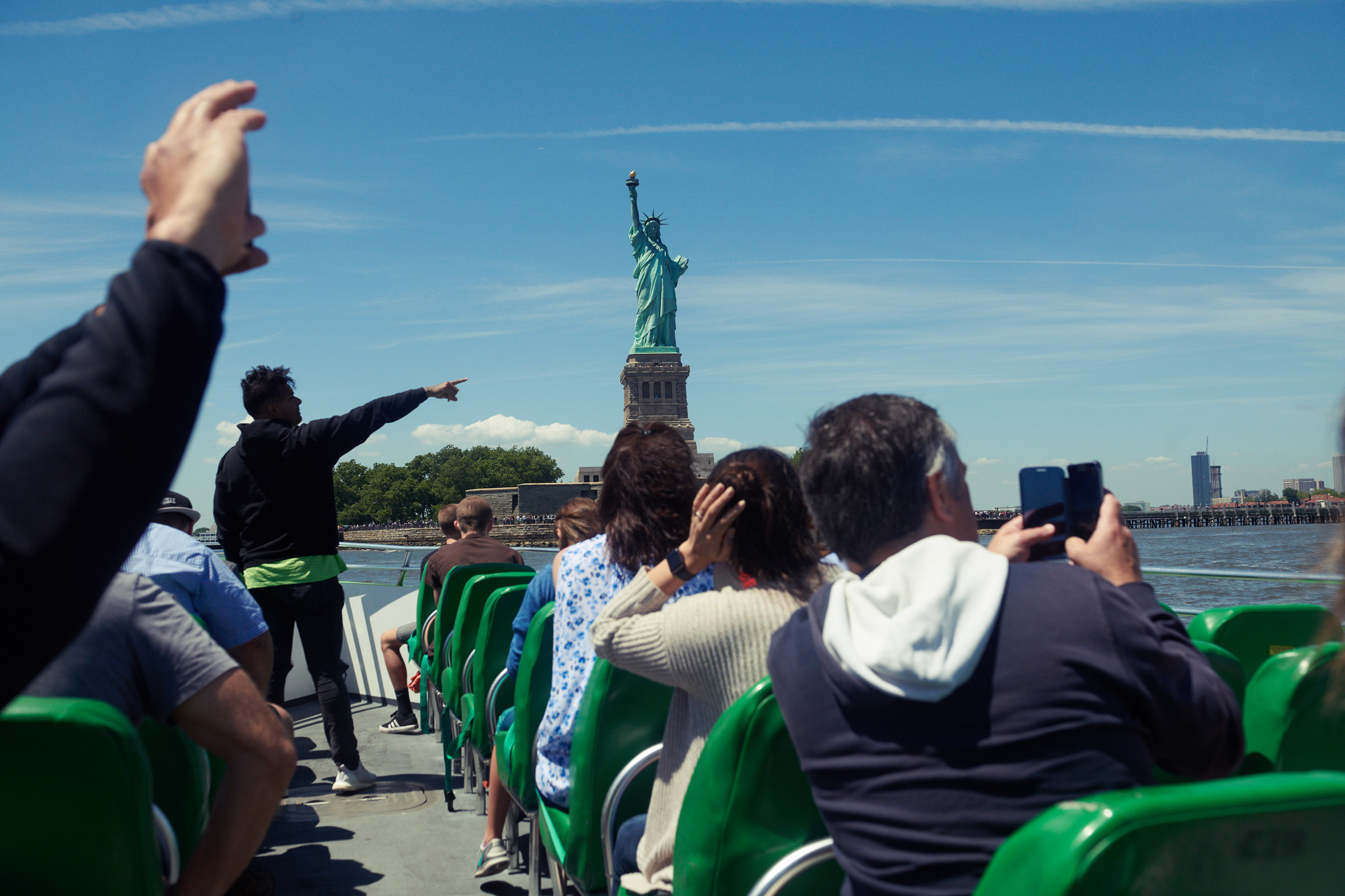 Passengers taking photos of the Statue of Liberty from the boat