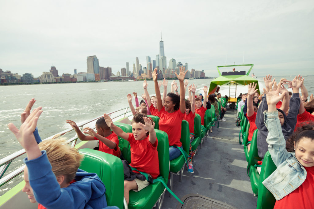 Passengers lifting their hands in excitement on The Beast